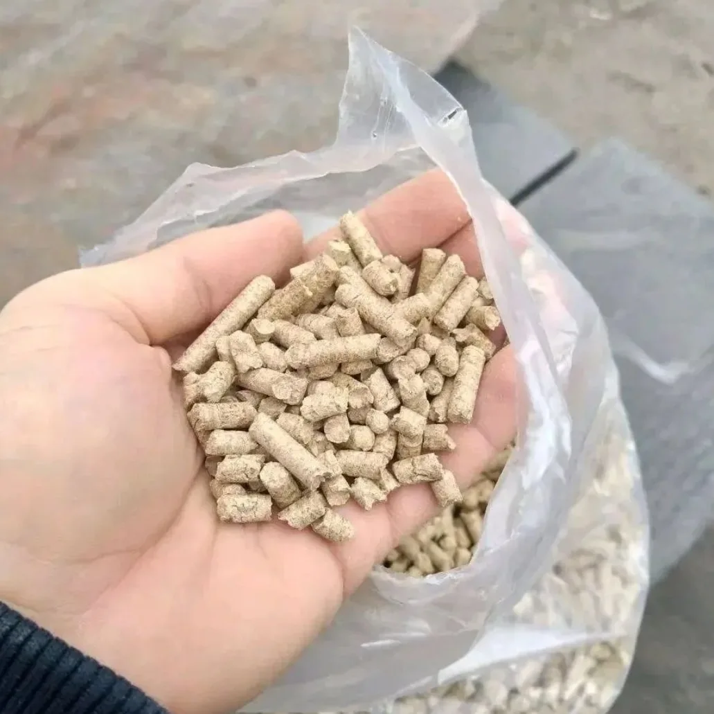 Handful of beech wood pellets held above an open bag