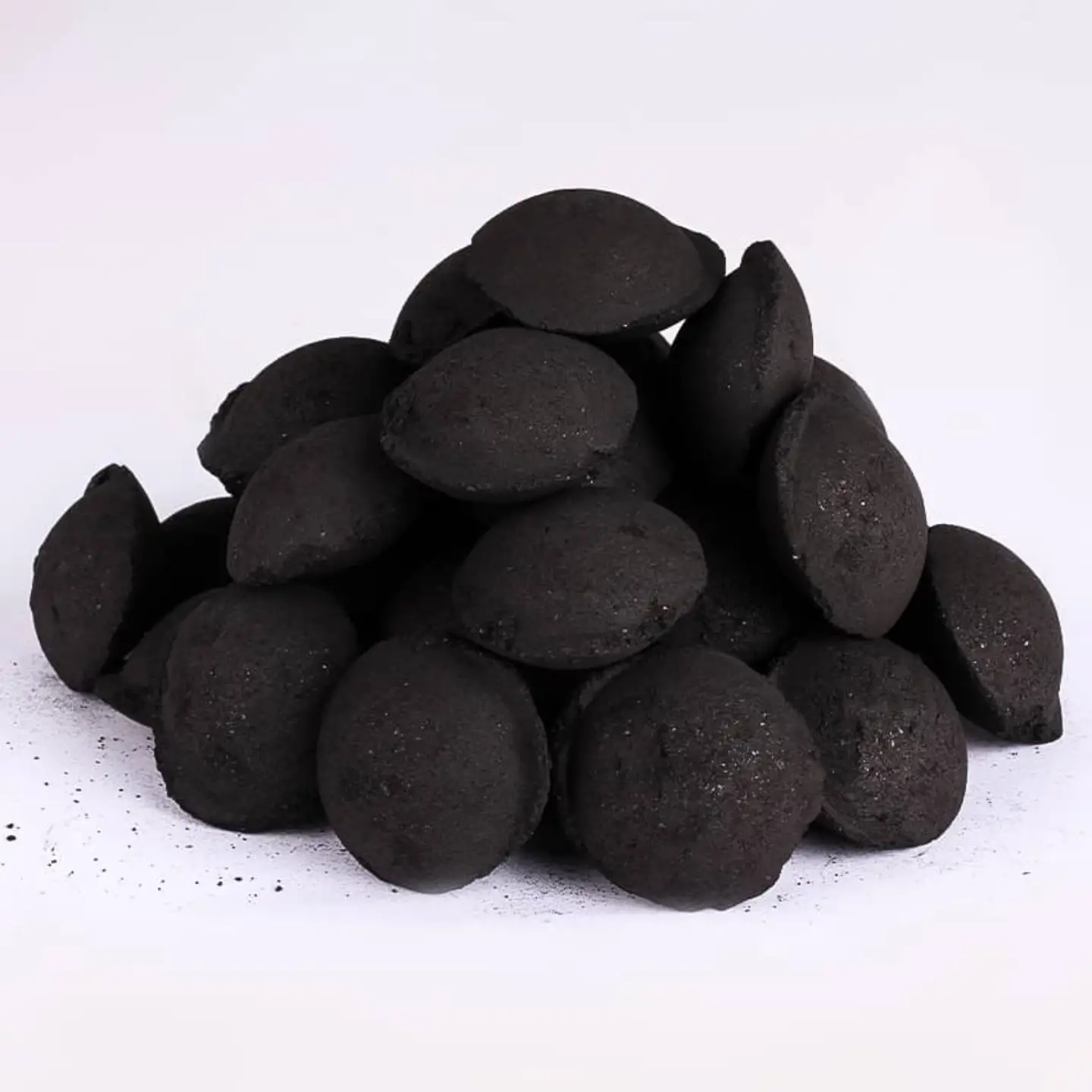 Pile of pillow-shaped compressed charcoal briquettes, KASUWOOD OÜ wholesale supply