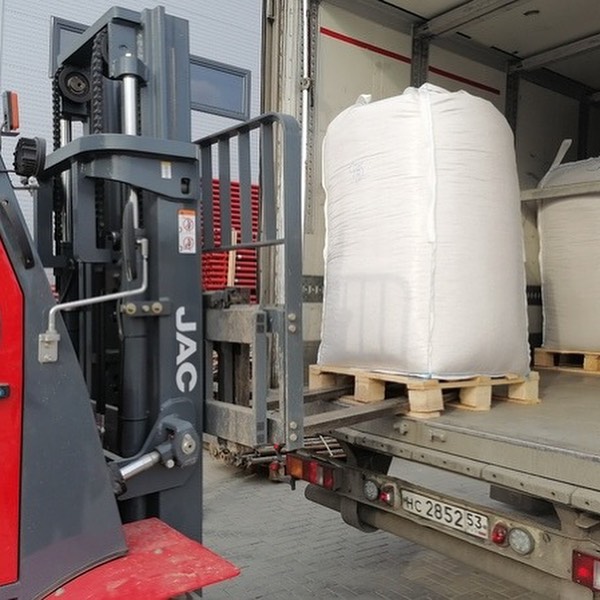 Forklift loading bulk wood pellet bags for dispatch