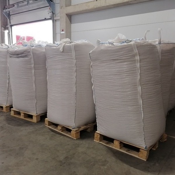 Industrial wood pellets 1 tonne bulk bags stacked in warehouse