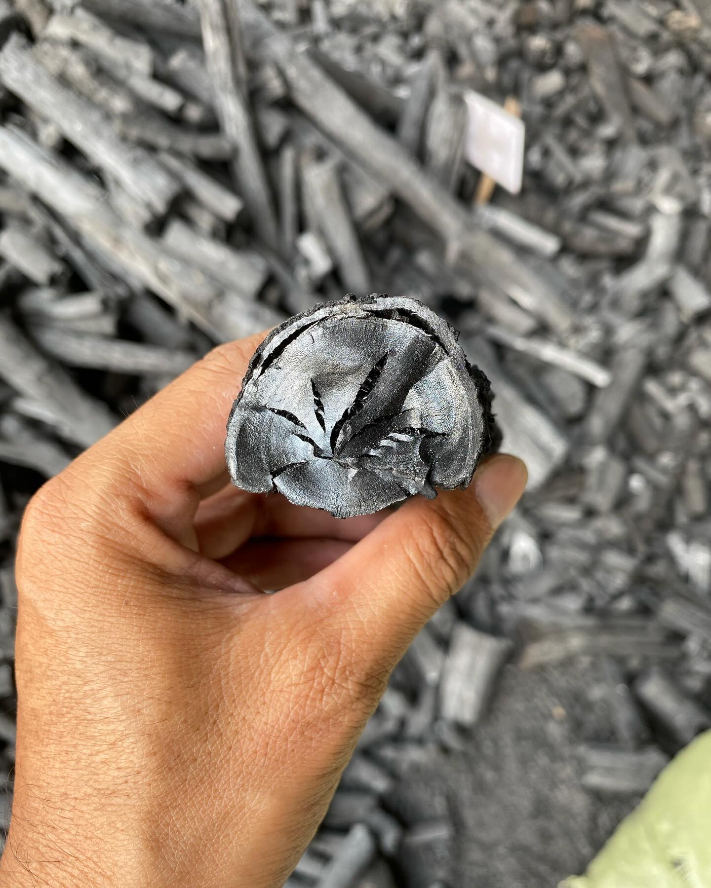 Hardwood charcoal logs stacked, ready for wholesale packaging