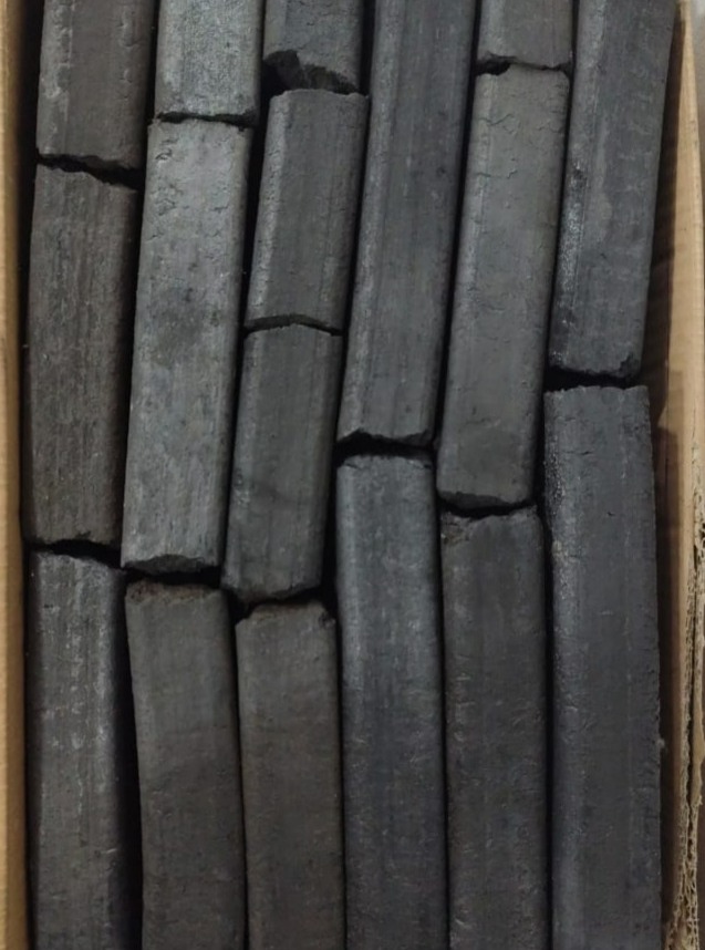 Mangrove charcoal log pieces laid out in rows