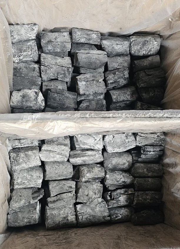 Mangrove charcoal pieces stacked inside a bag