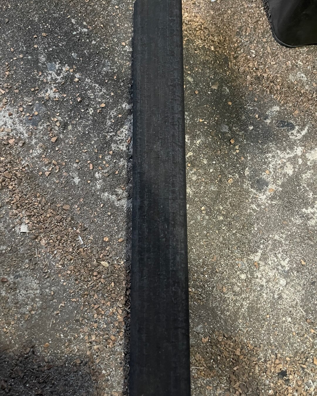 Close-up of a single rectangular orange/lemon/mango fruitwood charcoal stick