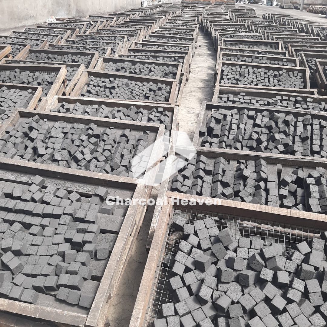 Crates of cube-shaped shisha charcoal outdoors
