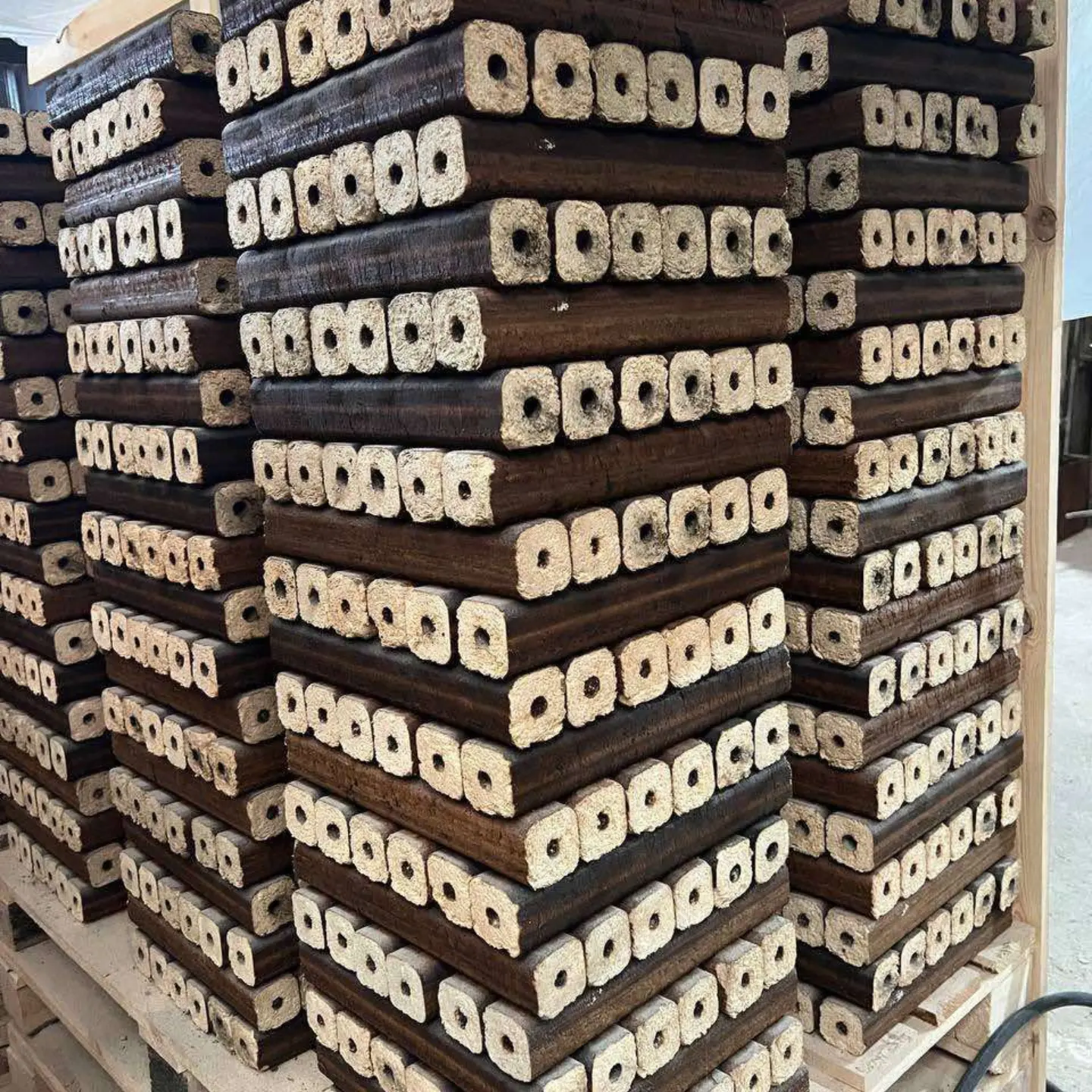 Pini and Kay hexagonal wood briquettes stacked for shipment